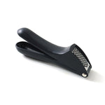 Garlic press kitchen tool placed neatly on a kitchen countertop