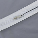 Closeup of full-length zipper on suit cover with breathable fabric.