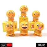 Front view of a funny bobblehead smiling face spring doll for desk decor.
