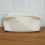 Open travel organizer pouch displaying internal compartments for toiletries