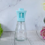 Efficient oil sprayer bottle being used to apply vegetable oil for a healthy meal.