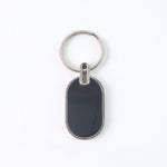 Monogram edge silver and black oval metal key holder accessory
