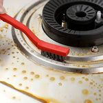 Compact wire brush in action, scrubbing a hard-to-reach area on a kitchen appliance.