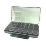 Empty 21-grid pill organiser on a clean surface, ready for medication loading.