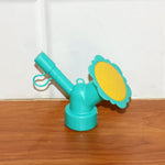 Bottle sprinkler head nozzle showing compact, portable gardening accessory