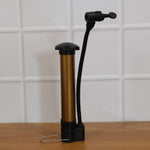 Side view of the Mini Hand Air Pump inflator with its needle securely attached, ready for inflation.