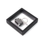 Nail clipper keychain attached to travel essentials with suitcase shape