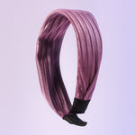 Dark ribbed knot hairband on white background showcasing textured fabric