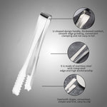 Set of two stainless steel serving tongs on a clear glass plate.