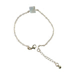 Detailed view of square stone charm on adjustable chain bracelet