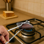 Close-up of heat-resistant handle on gas stove sandwich toaster for safe cooking