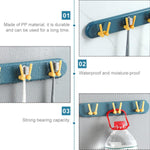 Modern wall-mounted bathroom shelf with hooks, perfect for hygienic toothbrush storage.