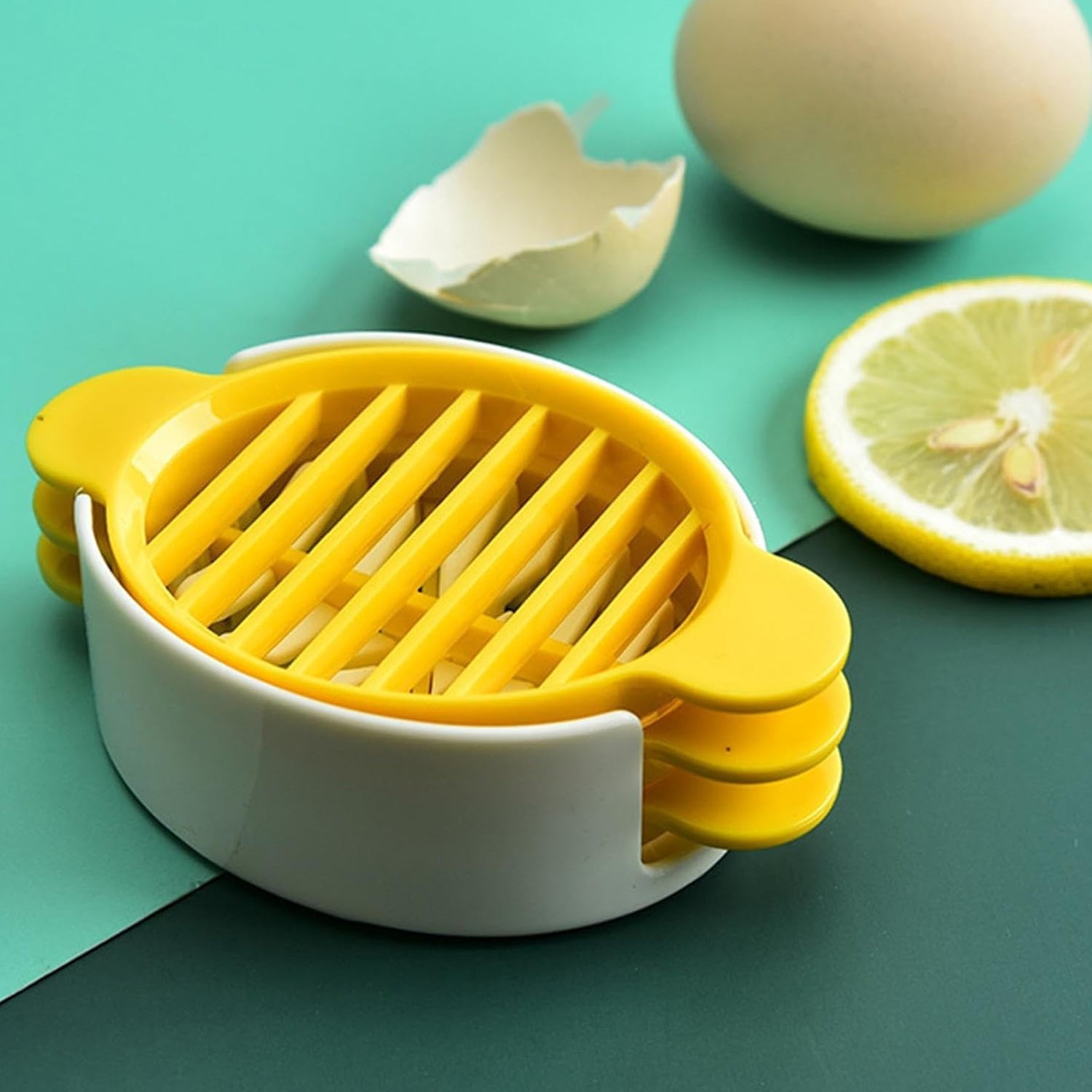 A hand using the plastic egg slicer to create perfect, even slices of a boiled egg.
