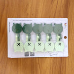 Self adhesive hooks used to hang measuring spoons in the kitchen