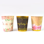 Set of disposable paper cups arranged neatly on a surface.