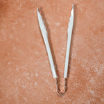 Cooking tongs featuring comfortable plastic handles for prolonged use.