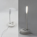 Compact Portable USB Fan and light connected to a power source.
