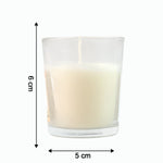 The Sweet Dreams Scented Votive Candle creating a serene ambiance on a bedside table.