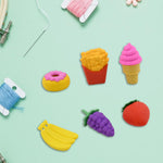 Detailed view of bright 3D cupcake and ice cream novelty erasers.