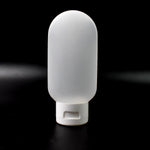 A single 60ml reusable plastic travel bottle in a vibrant mixed color, ready for toiletries.