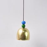 Close-up of metallic outdoor dragonfly wind chime with vibrant colors