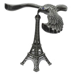 A hand demonstrating the Balancing Eagle Toy's stability by placing it on a fingertip, separate from its stand.