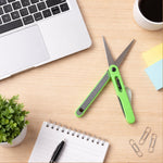Close-up view of the sharp blades on the portable pen-style scissors.