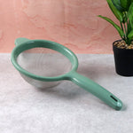 Fine mesh kitchen strainer filtering tea leaves for clear tea preparation