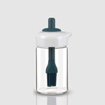 Glass oil dispenser with a brush, ideal for grilling, baking, or general cooking.