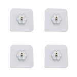 Transparent self adhesive hooks seamlessly blending into a tiled wall.