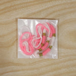 Detail shot of Pink & White Thread Rakhi with golden beads