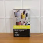Set of four multi-colour plastic wall holders mounted on a sleek stainless steel surface.