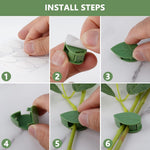 Several green plant climbing wall clips arranged neatly on a wall.