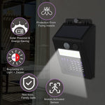 Sun-powered mosquito zapper and outdoor light mounted near a doorway.