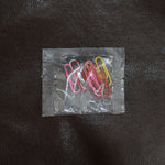 Colourful vinyl-coated paper clips securely holding important files and documents together.