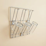 Wall-mounted stainless steel cup rack holding multiple drinkware