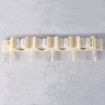 Close-up of self-adhesive broom holder rack mounted on home wall