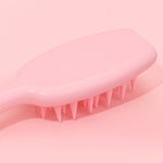 Silicone scalp scrubber shampoo brush showing gentle bristles