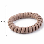 Coil hair band displayed on flat surface showing texture