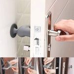 Silicone door handle protector preventing a door handle from hitting the wall.