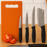 Tempered stainless steel kitchen knives next to plastic chopping board