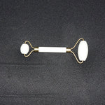 Dual-ended face massage roller displayed on a minimalist white background.