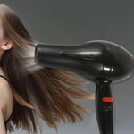 Hair dryer in action, creating a sleek hairstyle for Indian hair.