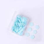Detailed view of flower-shaped soap sheets beginning to dissolve in water.