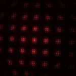 A galaxy projector creating a romantic starry night effect in a dimly lit room.