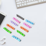 Flexible cable protector wrapped around a white earphone cable.
