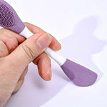 Ergonomic design of the double-headed silicone brush held comfortably for skincare application.