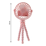Portable fan mounted on flexible tripod stand in use outdoors