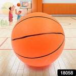 A child's hand holding the high-bouncing mini basketball on a playground.