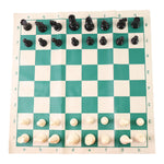 Plastic chess set pieces arranged on the roll-up green and white chess board